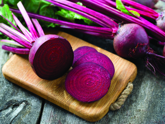 fresh sliced beetroot on wooden surface
