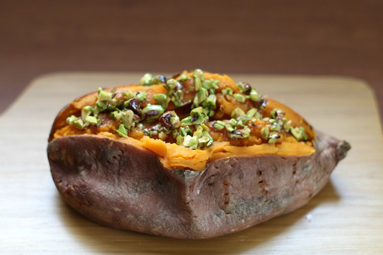 Baked sweet potato topped with honey-pistachio mixture