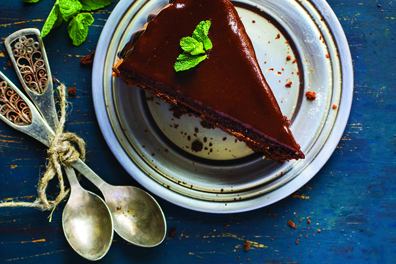 Piece of chocolate cake with mint leaves