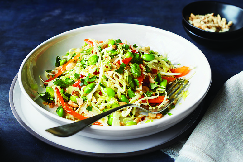 edamame slaw in white bowl with fork
